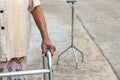 TheÃ¢â¬â¹ Asian old woman standing with his hands on a walking stick,Hand of old woman holding a staff cane
